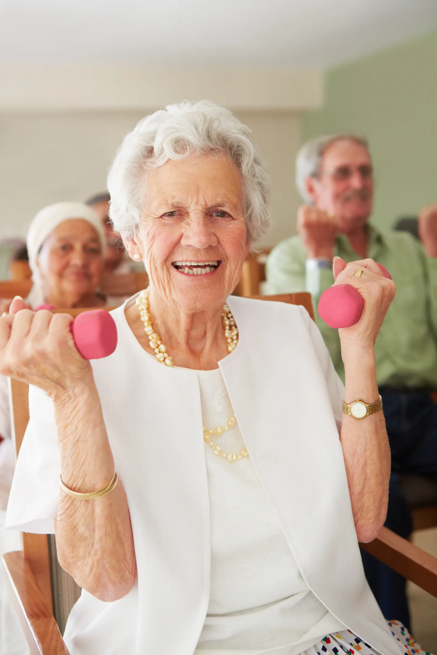 Senior woman using light weights to strengthen her muscles at Ridgeview Village Texas